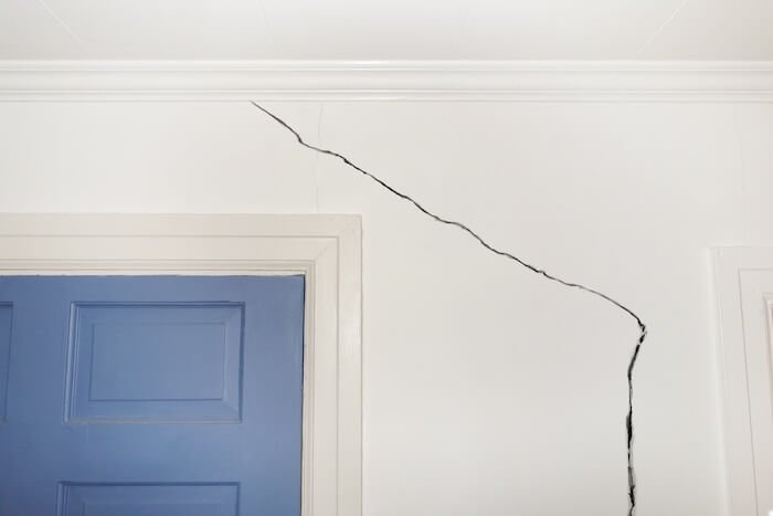 Crack in drywall running alongside a door