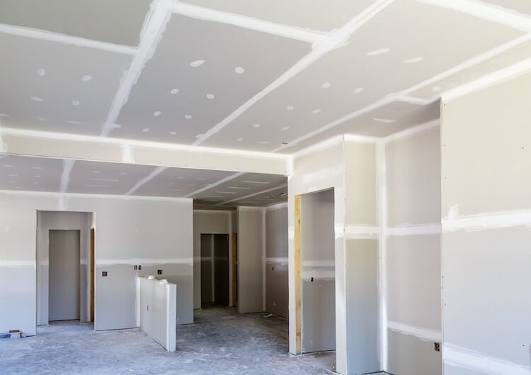 A room with exposed and installed drywall