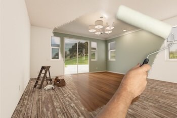 A roller brush stroke over a room being painted.